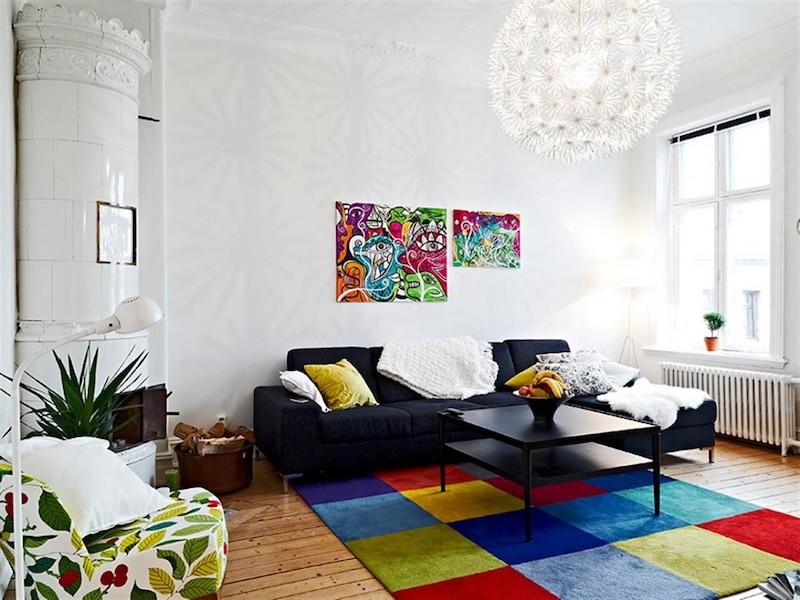 a white bedroom with colorful flooring