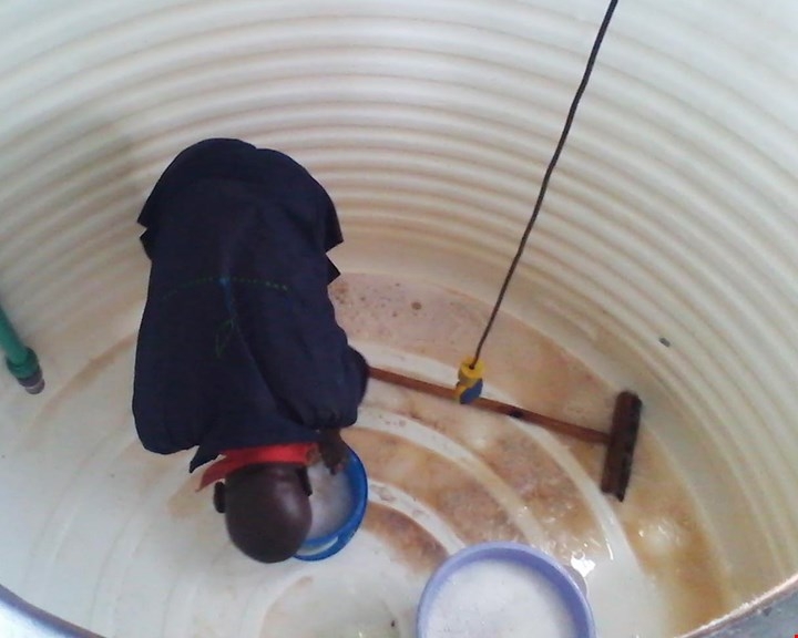 a cleaner cleaning a water tank