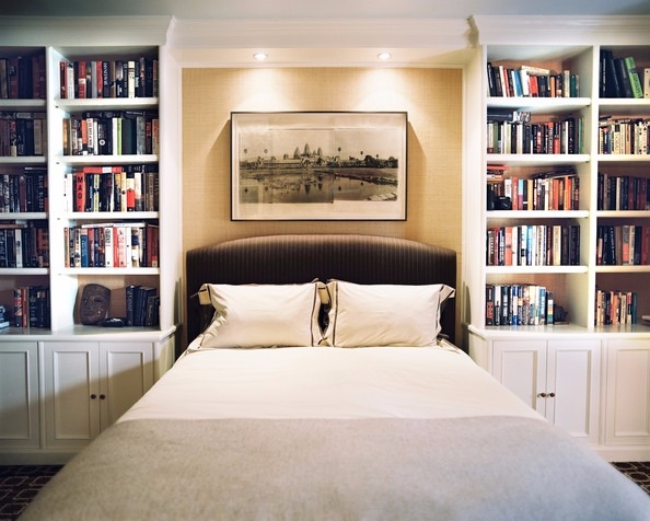 bedroom with organized books on each side
