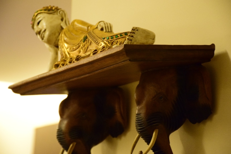 reclining Buddha idol on shelf