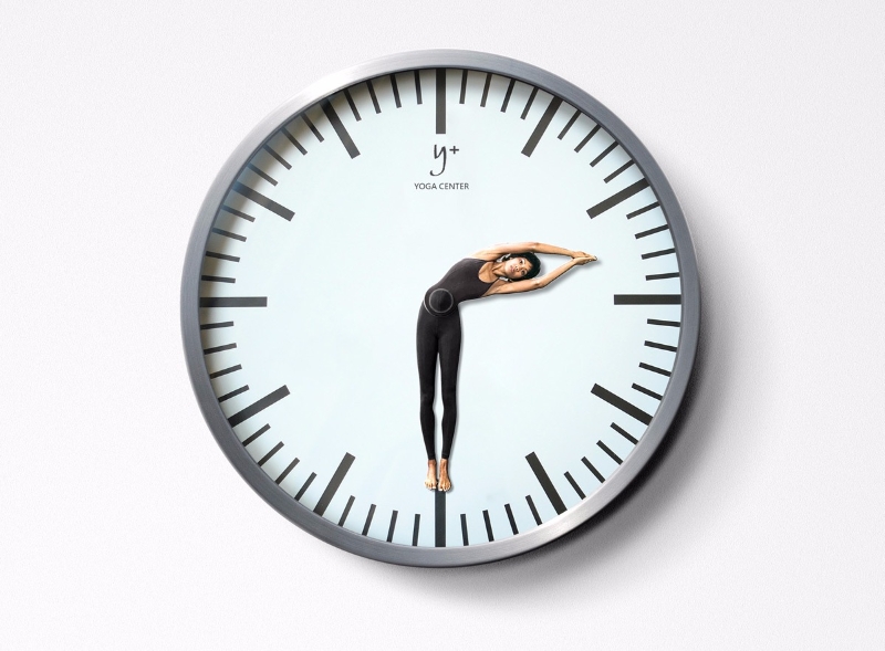 clock with a woman doing yoga inside it instead of the needles
